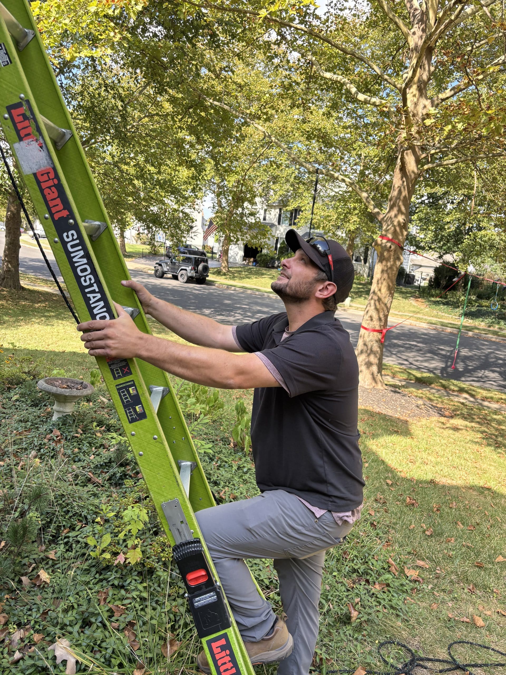 Pest control technician climbing a ladder for a free inspection of a Florida home.