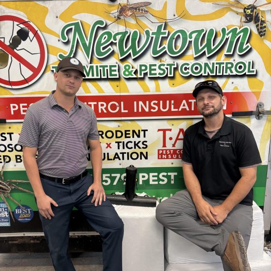 Newtown Pest Control Florida technicians standing by a company truck, showing 30+ years of local experience.