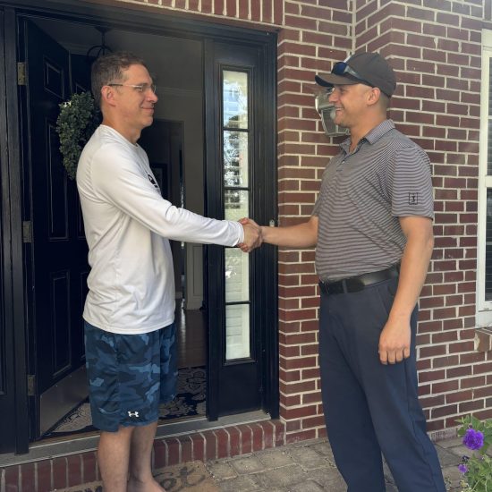 Pest control technician shaking hands with a happy client after guaranteed service completion at newtown pest control florida